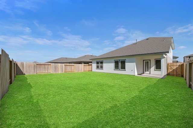 rear view of property featuring a lawn