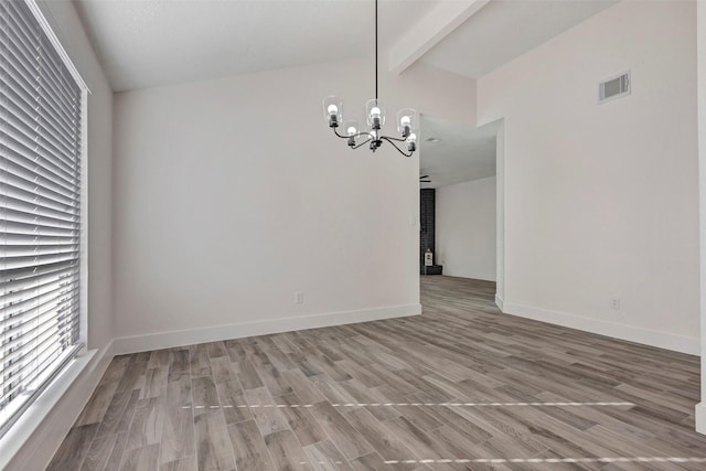 unfurnished dining area with wood-type flooring, a chandelier, and vaulted ceiling with beams