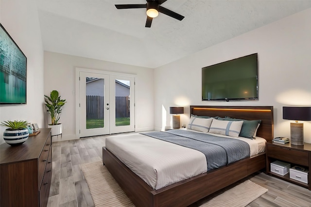 bedroom featuring light hardwood / wood-style flooring, access to outside, french doors, and ceiling fan