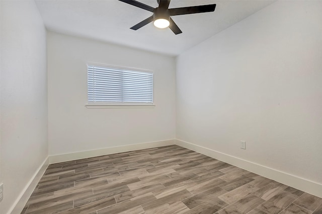 empty room featuring ceiling fan and hardwood / wood-style floors