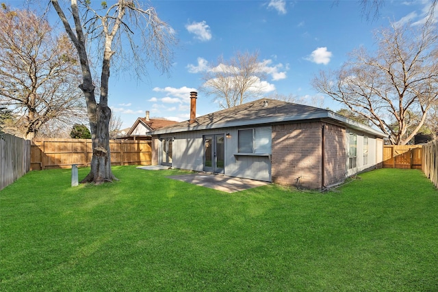 back of house featuring a yard and a patio area