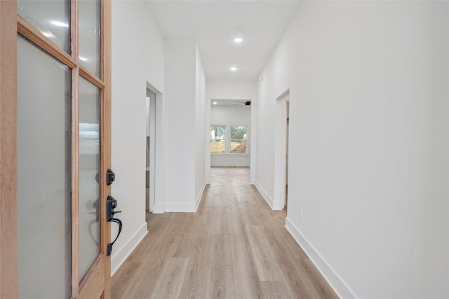 corridor with light hardwood / wood-style floors
