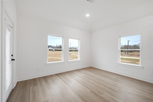 empty room with light hardwood / wood-style flooring