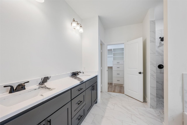 bathroom featuring vanity and tiled shower