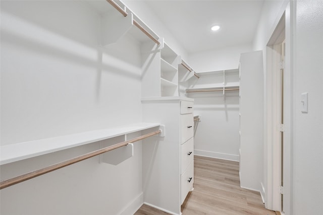 spacious closet with light hardwood / wood-style flooring
