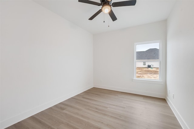 empty room with ceiling fan and light hardwood / wood-style floors