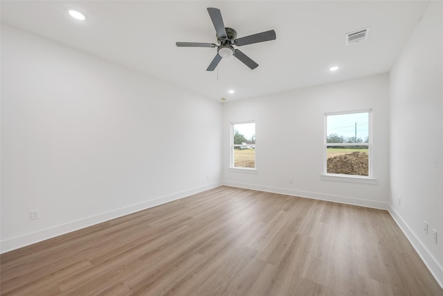 empty room with light hardwood / wood-style floors and ceiling fan