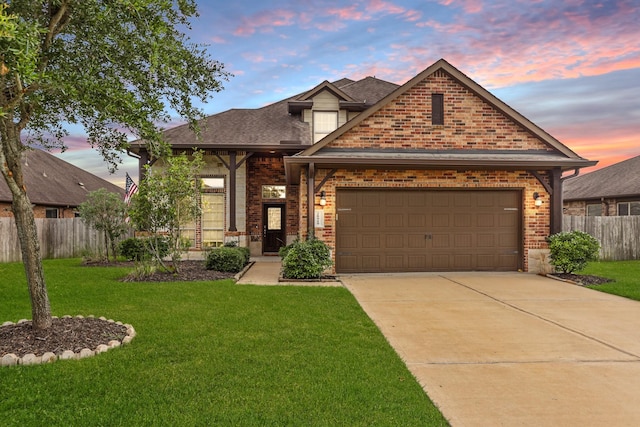 craftsman-style home with a garage and a yard