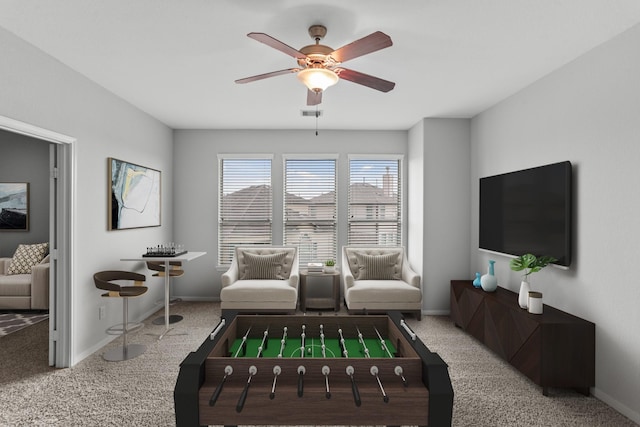 carpeted living room with ceiling fan