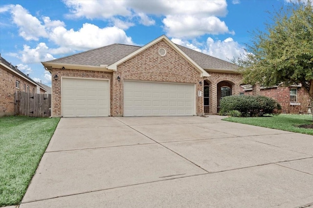 view of front of property with a garage and a front lawn