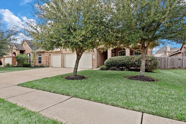 obstructed view of property featuring a garage and a front lawn