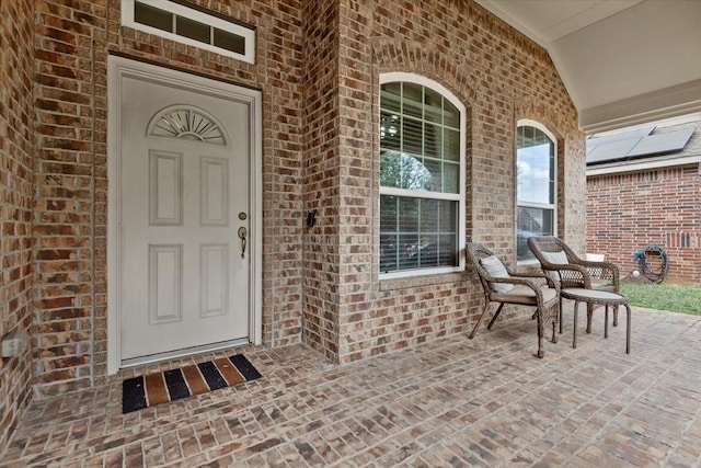 view of exterior entry with a porch