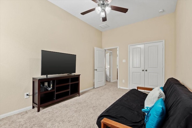 living area featuring ceiling fan and light colored carpet