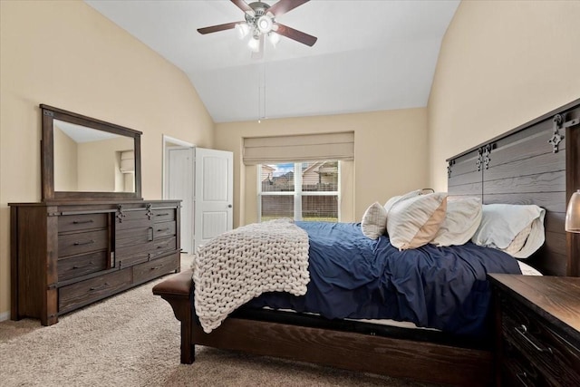 carpeted bedroom with vaulted ceiling and ceiling fan