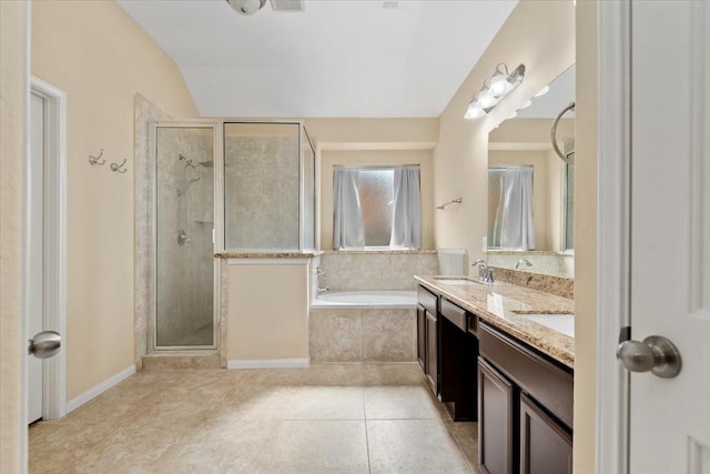 bathroom with lofted ceiling, tile patterned floors, shower with separate bathtub, and vanity