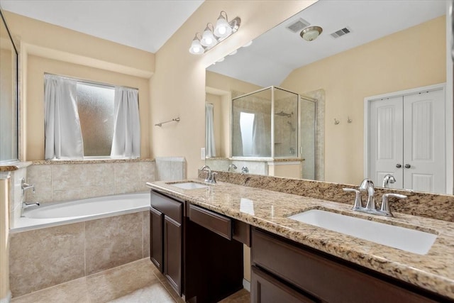 bathroom with independent shower and bath, vanity, and tile patterned flooring