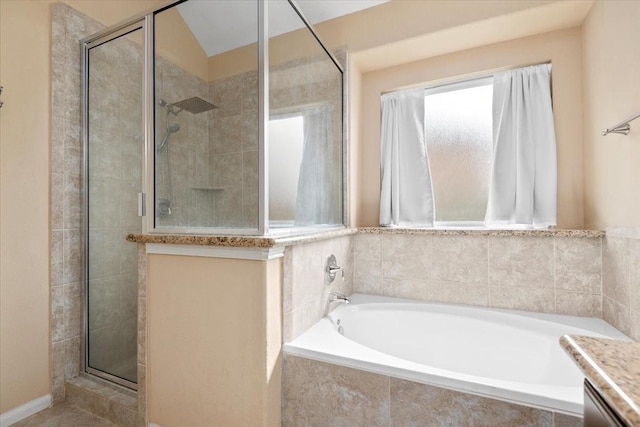 bathroom with vanity and shower with separate bathtub