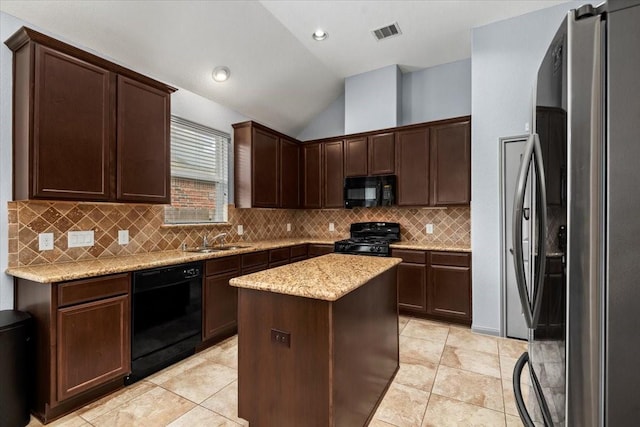 kitchen with vaulted ceiling, a kitchen island, tasteful backsplash, sink, and black appliances