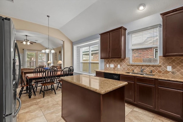 kitchen with a kitchen island, decorative light fixtures, lofted ceiling, sink, and stainless steel fridge with ice dispenser