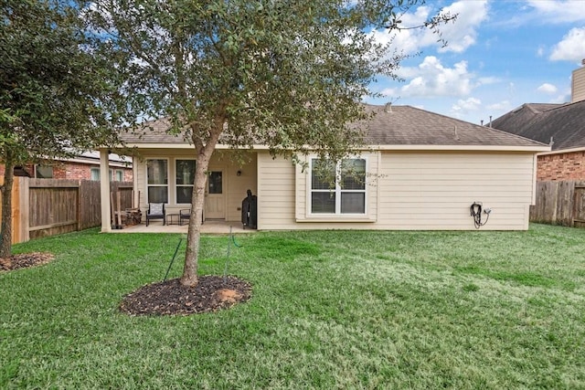 back of property featuring a yard and a patio