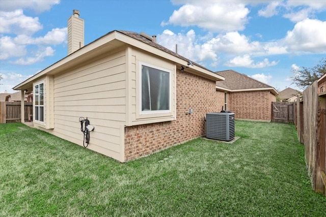 view of property exterior with a yard and central AC unit