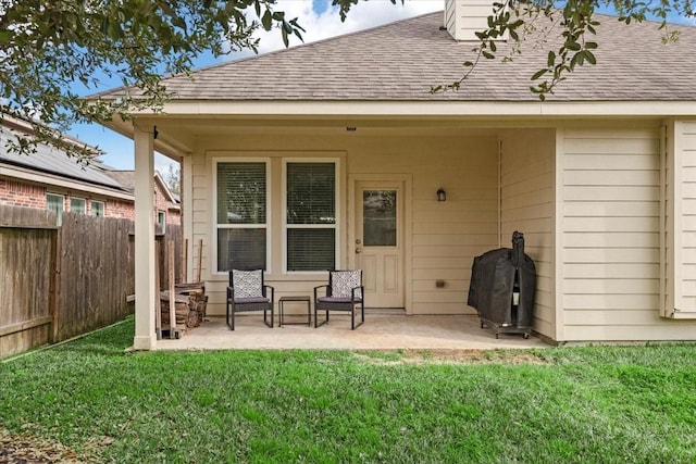 back of house featuring a patio area and a lawn