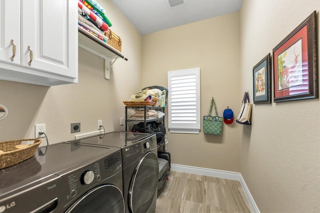 laundry area featuring independent washer and dryer and cabinets