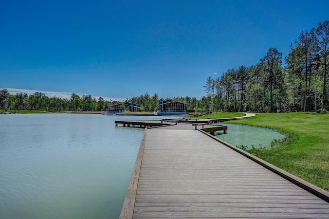 dock area featuring a water view and a lawn