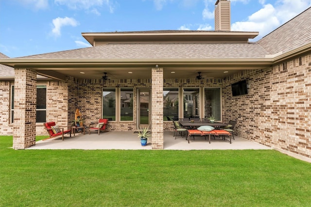 back of property featuring ceiling fan, a patio area, and a lawn