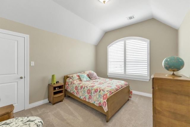 bedroom featuring light colored carpet and lofted ceiling