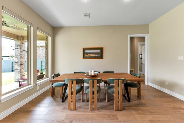 dining space with light hardwood / wood-style flooring