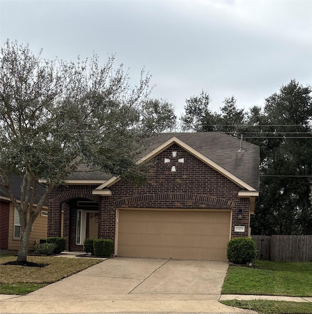 view of front of house featuring a garage and a front lawn