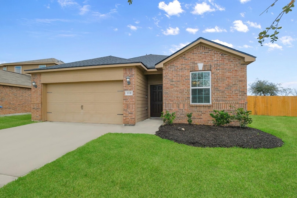 view of front of property featuring a garage and a front yard