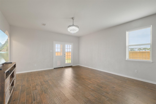 unfurnished living room featuring dark hardwood / wood-style flooring