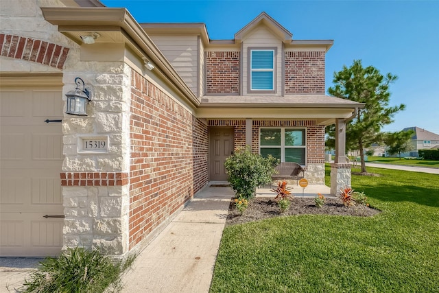 doorway to property featuring a yard and covered porch