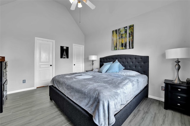 bedroom with high vaulted ceiling, hardwood / wood-style floors, and ceiling fan