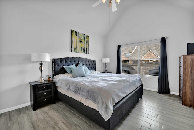 bedroom featuring hardwood / wood-style flooring, lofted ceiling, and ceiling fan