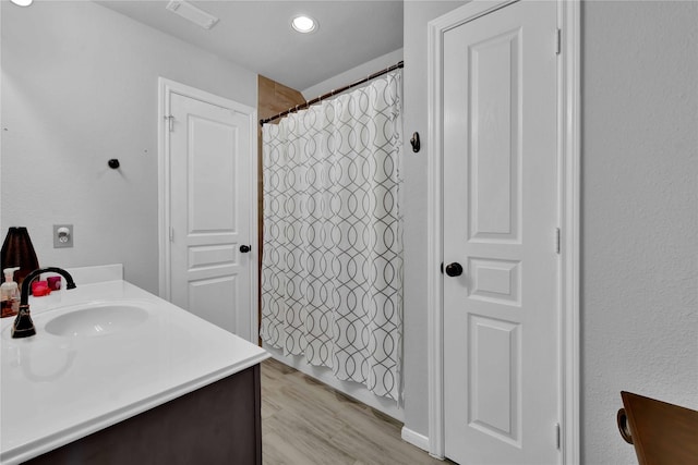 bathroom featuring vanity, hardwood / wood-style floors, and a shower with shower curtain