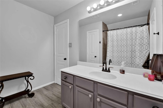 bathroom with vanity, a shower with curtain, and hardwood / wood-style flooring