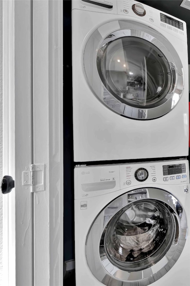 clothes washing area featuring stacked washer / drying machine