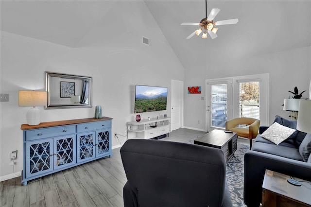 living room with ceiling fan, high vaulted ceiling, and light hardwood / wood-style floors