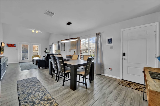 dining space with vaulted ceiling