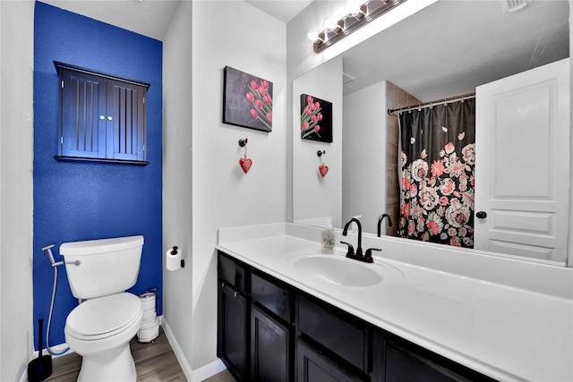 bathroom featuring vanity, hardwood / wood-style floors, and toilet