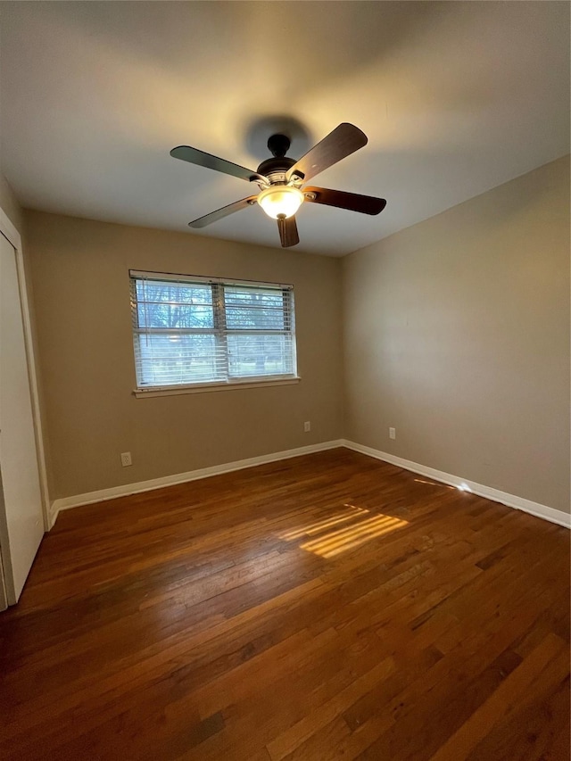 unfurnished bedroom with ceiling fan and dark hardwood / wood-style floors