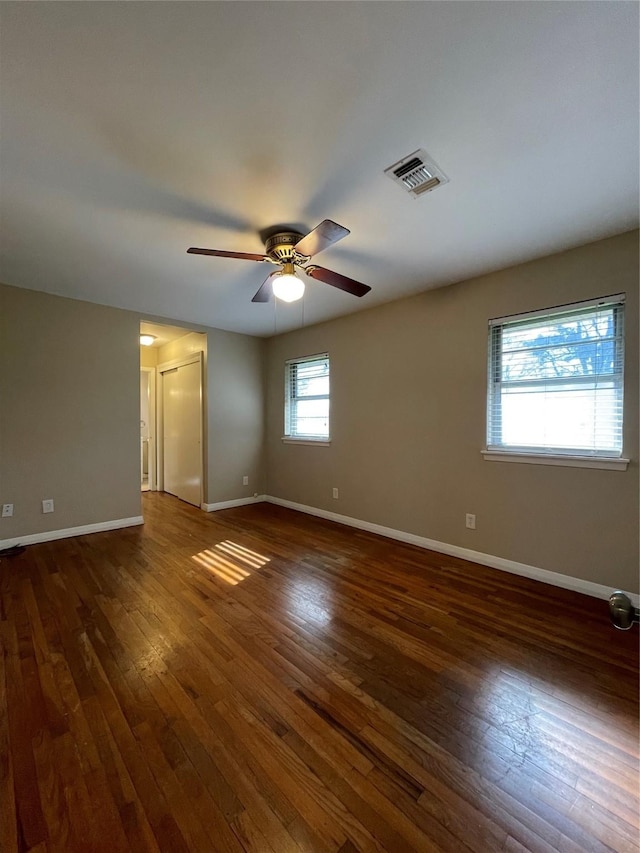 unfurnished room with dark hardwood / wood-style floors and ceiling fan