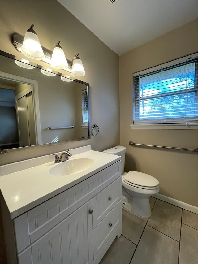 bathroom featuring tile patterned flooring, vanity, and toilet