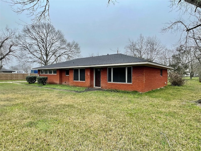 back of house featuring a lawn