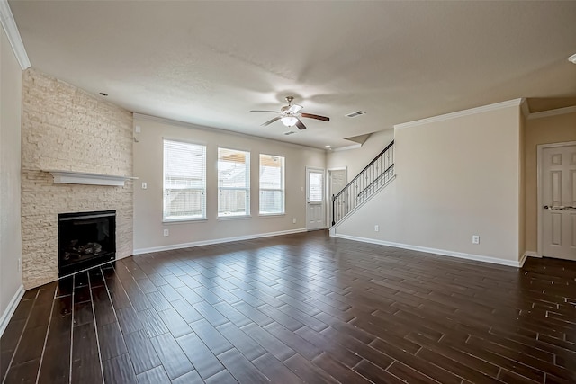 unfurnished living room featuring stairs, visible vents, a fireplace, and dark wood-type flooring