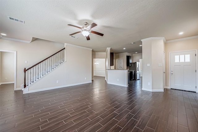 unfurnished living room featuring dark wood-style floors, stairway, visible vents, and a ceiling fan