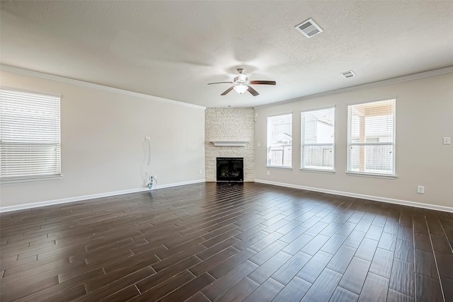 unfurnished living room featuring dark wood-style floors, a fireplace, visible vents, and a ceiling fan